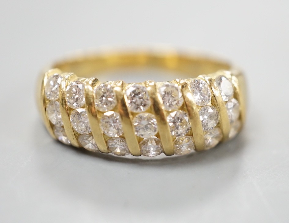 A modern 18ct gold and twenty one stone diamond set seven row half hoop ring, size N, gross weight 4.5 grams.